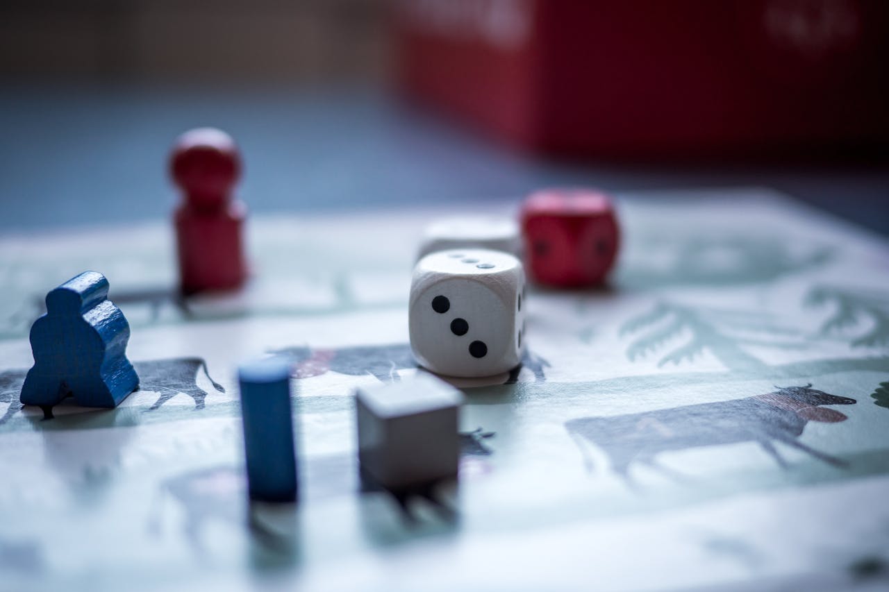 Close-up view of board game pieces and dice on a game board. Perfect for recreation and strategy themes.